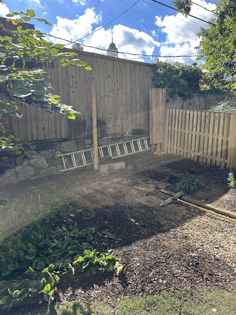 Same backyard corner after shed demolition — Arlington VA