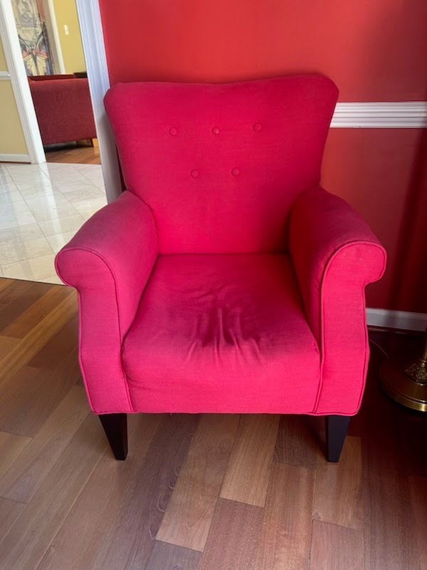 Red upholstered armchair before removal — Preserve at Wynmar, Chantilly VA
