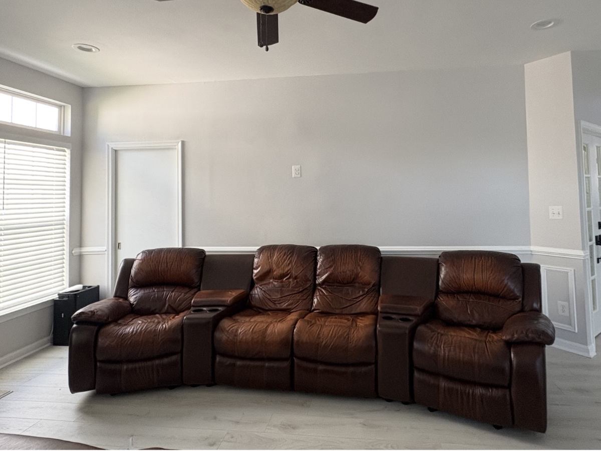 Leather home theater seating in living room before removal — Ashburn, VA