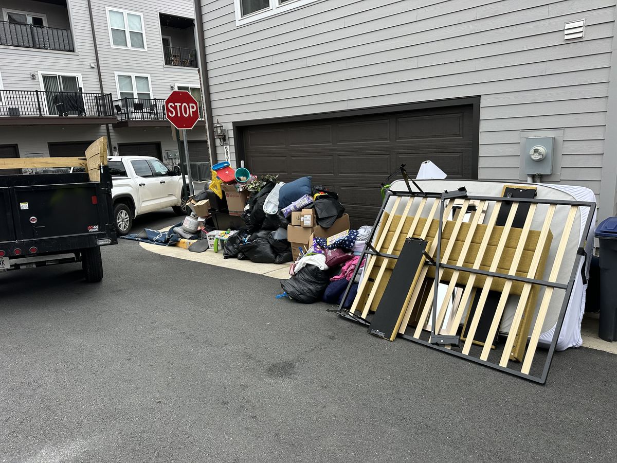 Moving debris stacked in front of garage before cleanout — Ashburn, VA