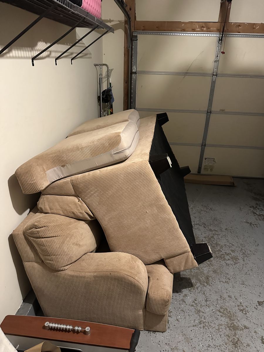 Loveseat and sofa staged in garage for removal — Herndon, VA