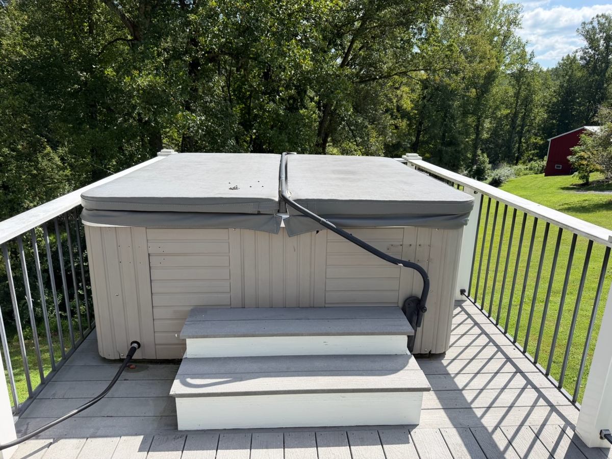 30-year-old hot tub on a second-floor deck before removal — Clifton, VA