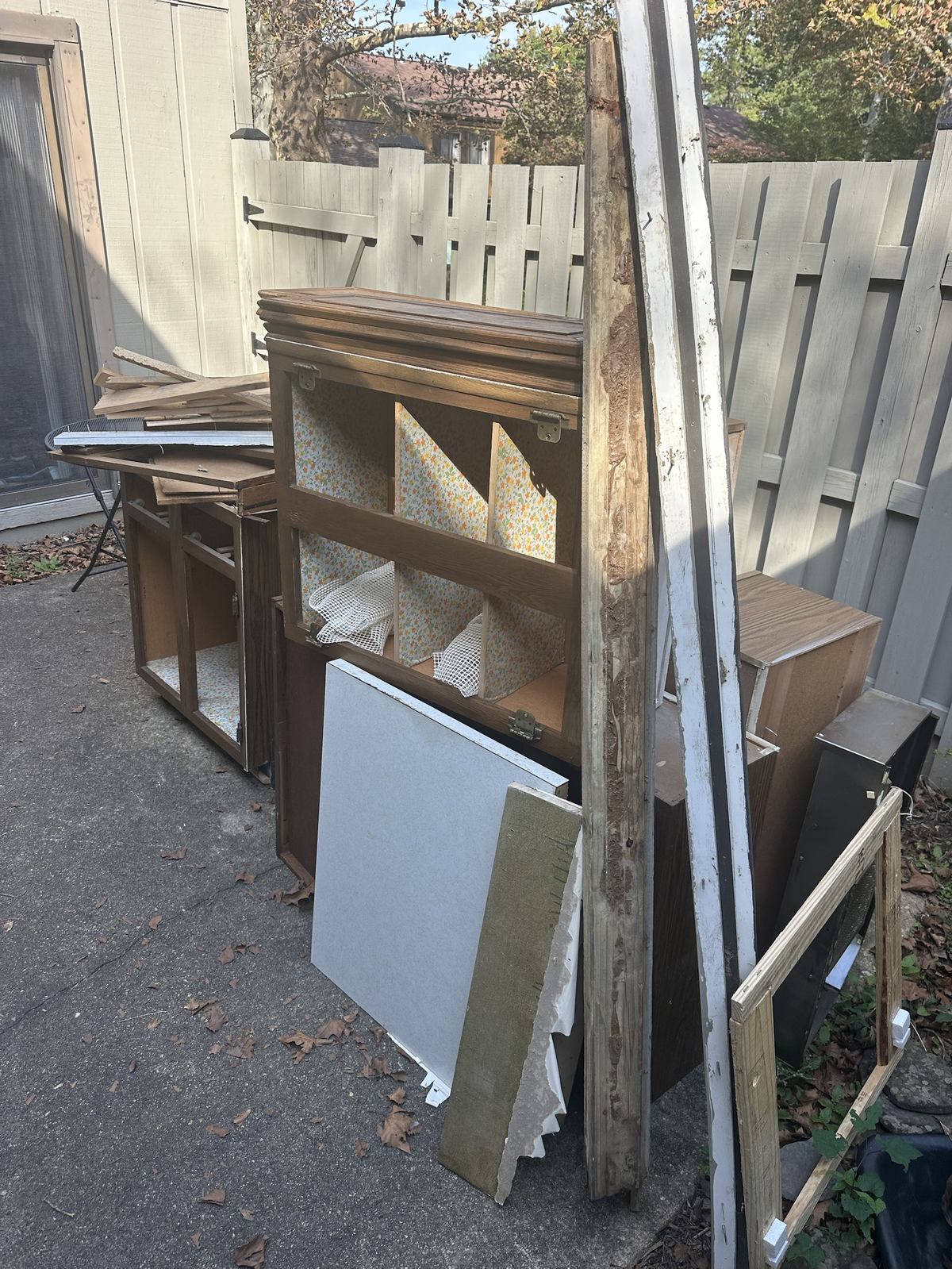 Kitchen cabinet carcasses and debris piled for pickup — Ashburn, VA