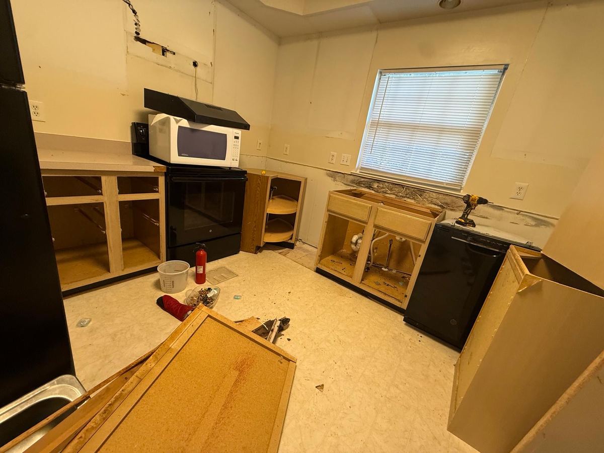 Kitchen further along in demolition, upper cabinets removed