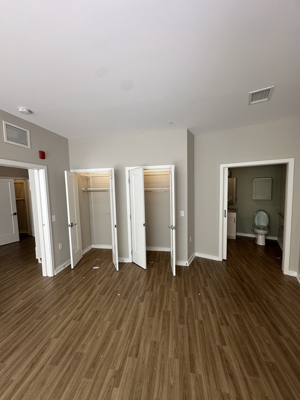 Empty assisted living bedroom with closets open after cleanout — Herndon, VA