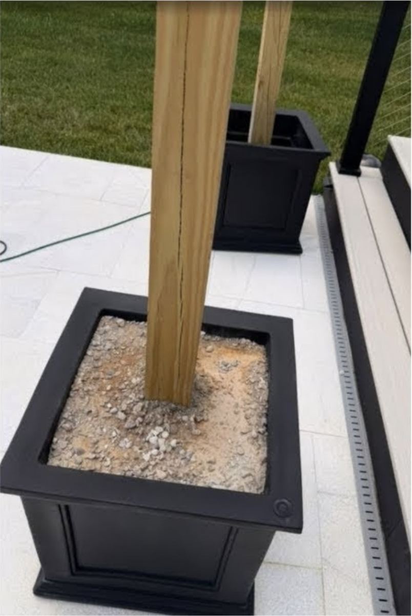 Close-up of concrete footing on fence post — South Riding, VA