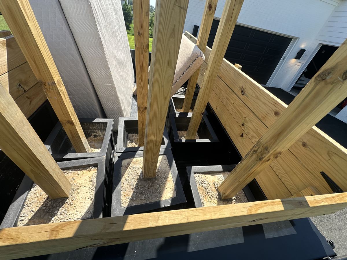 Concrete-filled fence posts loaded onto trailer for disposal — South Riding, VA