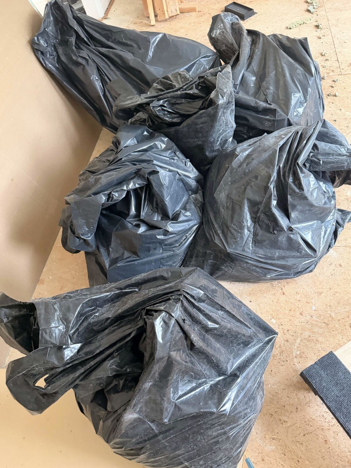 Bagged construction debris on subfloor — Vienna VA renovation