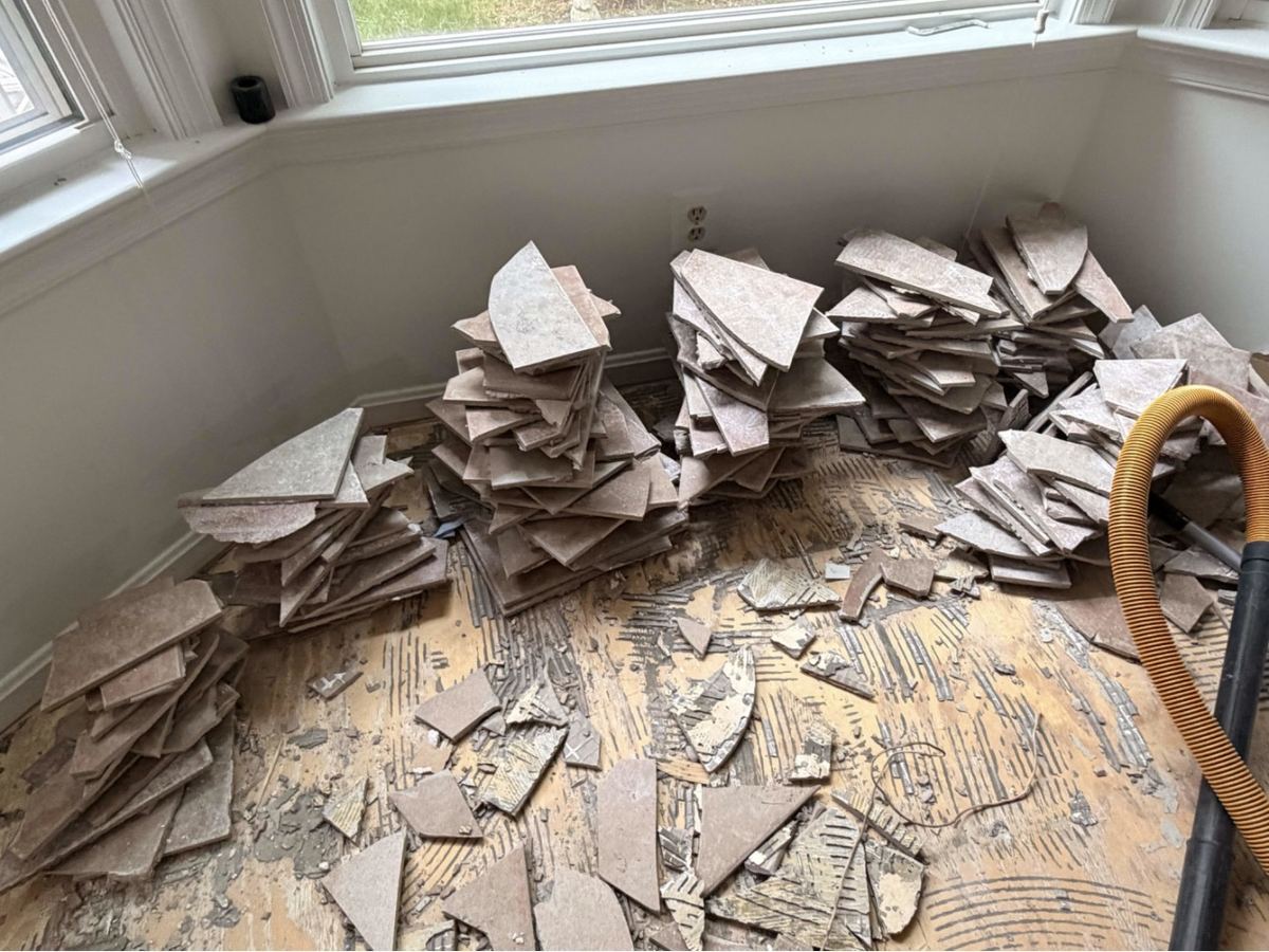 Torn-up tile debris before removal — Vienna VA renovation